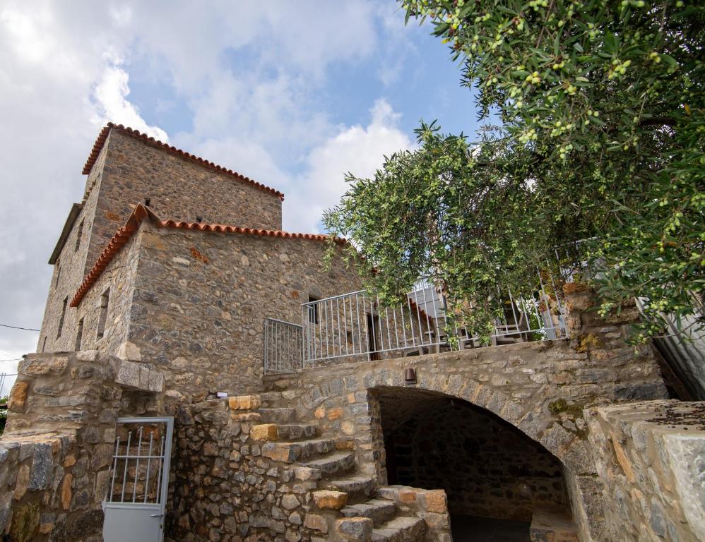an old stone building with a stone staircase at Armonia Sun Tower in Exochori