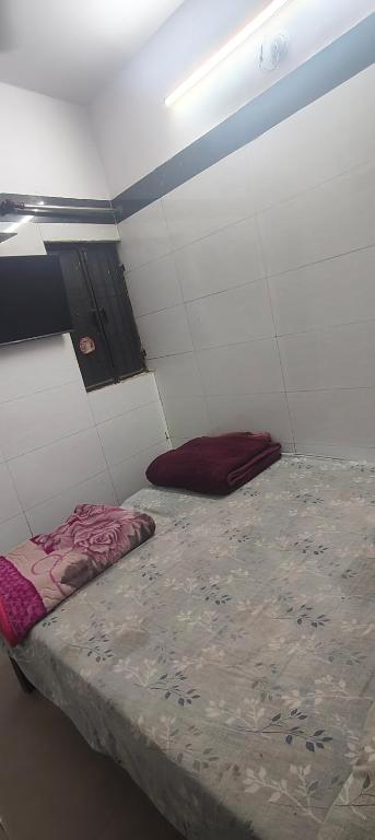 a small room with a bed in the corner at Panchmukhi inn hotel in Lucknow