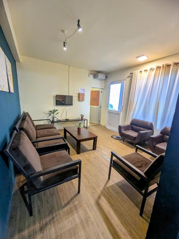 a living room with chairs and a couch and a table at Relax Apartment Toppass in Nuwara Eliya
