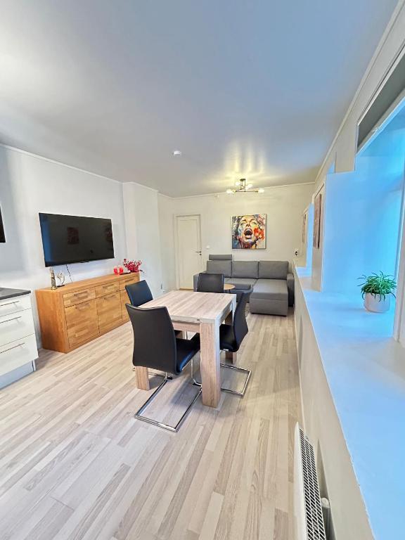 a living room with a table and chairs and a couch at Cozy Apartment in Central Alesund Close to Everything in Ålesund