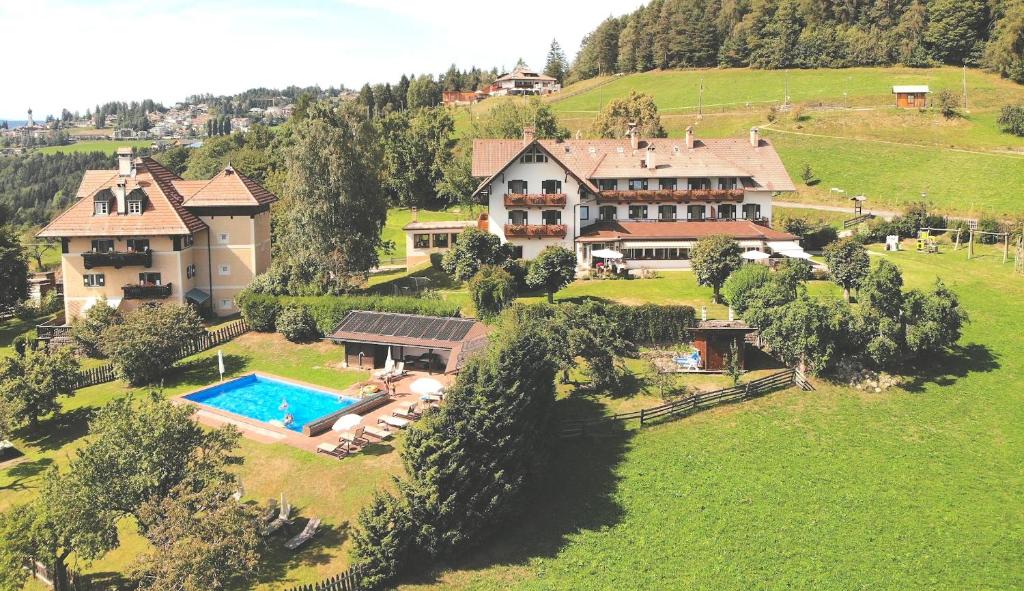 an aerial view of a large house with a swimming pool at Villa Maier B&B & Apartments in Soprabolzano