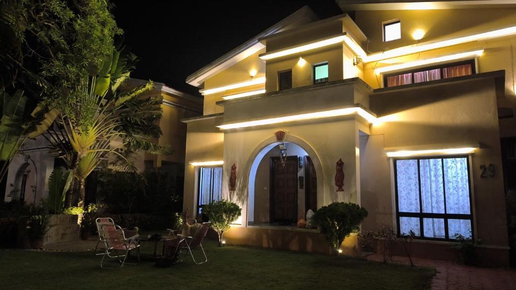 a house at night with a table and chairs at Gardenia 29 in Raichak