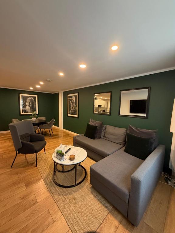a living room with a couch and a table at GRAPHITE APARTMENTS in Inverness