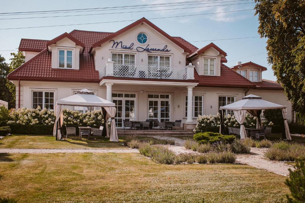 a house with two umbrellas in front of it at Miód Lawenda in Biardy