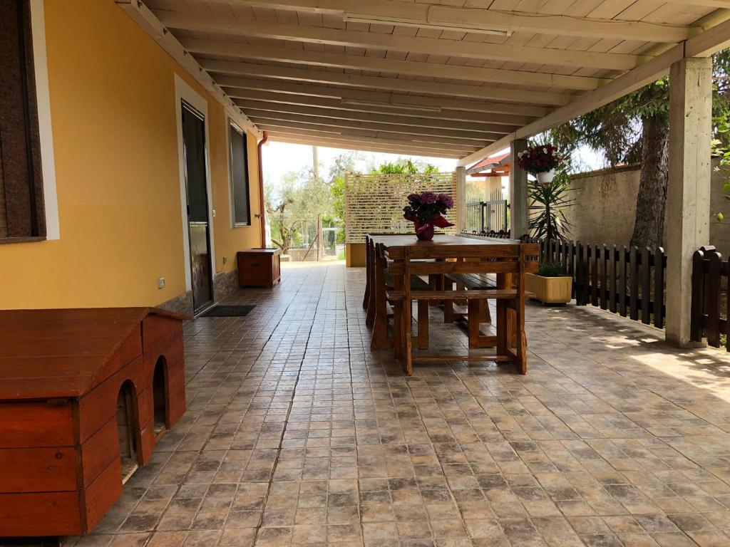 a patio with a table and a bench on it at La Presentosa in Ortona