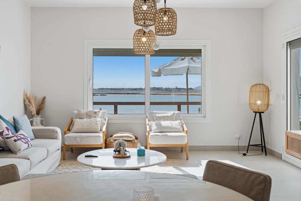 a living room with a view of the water at The Sandy Feet Sea Front in Hurghada