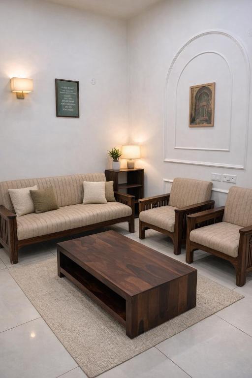 a living room with couches and a coffee table at Guest Stay Inn 1BHK in Zirakpur