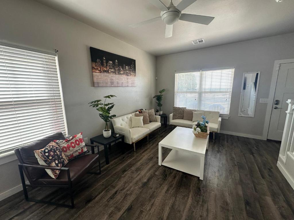 a living room with a couch and a table at Spacious Family Townhouse in Edmond