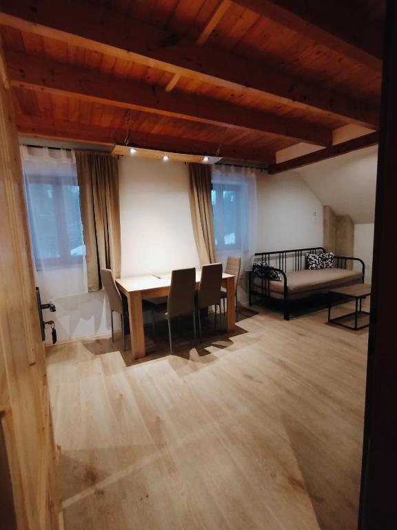 a room with a table and chairs and a bed at Apartmány v Bývalém mlýně in Rokytnice v Orlických Horách