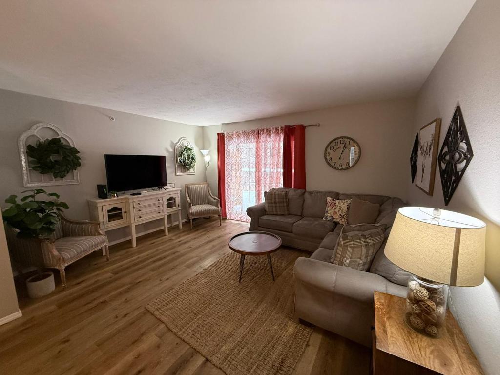 a living room with a couch and a tv at Branson Ridge Retreat in Branson