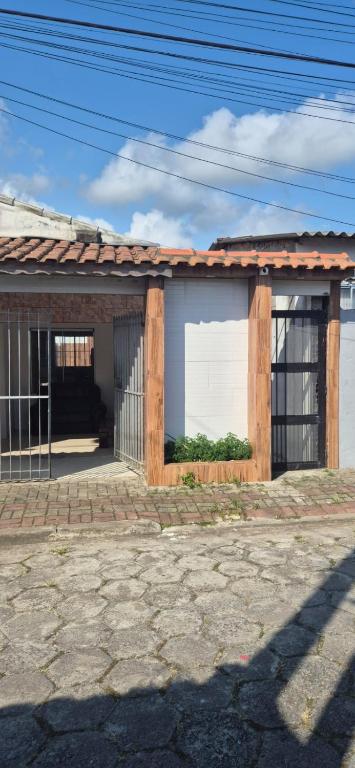 a building with a large window on the side of it at Cantinho de conforto in Mongaguá