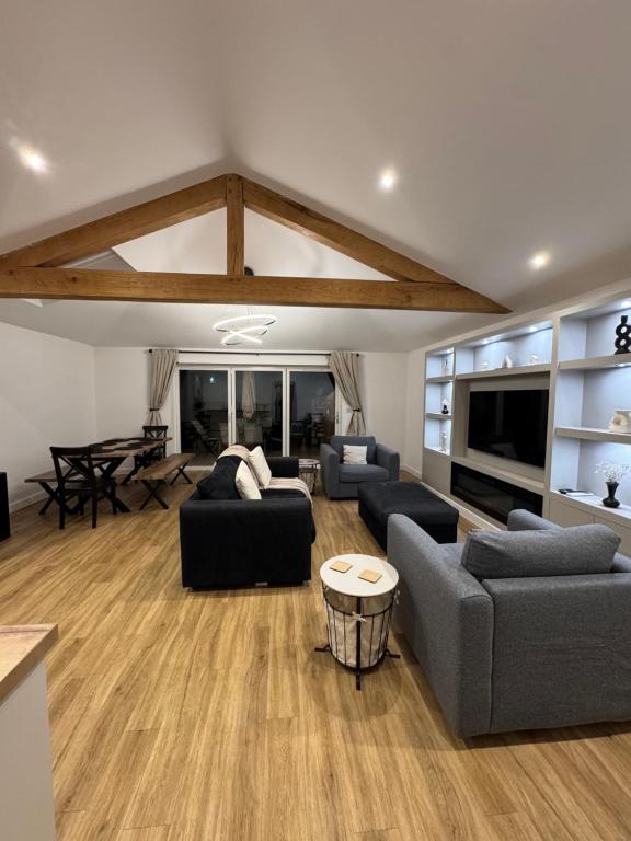 a living room with two couches and a table at The Brambles bungalow in Weston-super-Mare