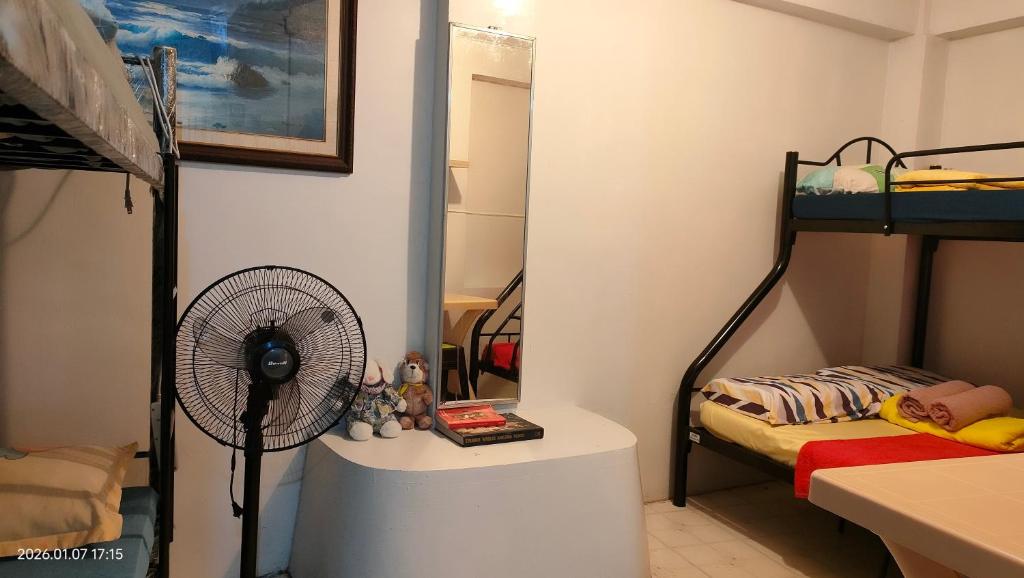 a room with a fan and a bunk bed at Kochimoto Guestroom in Baguio