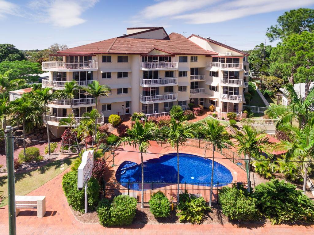 an aerial view of a resort with a swimming pool at Charlton on The Esplanade in Hervey Bay