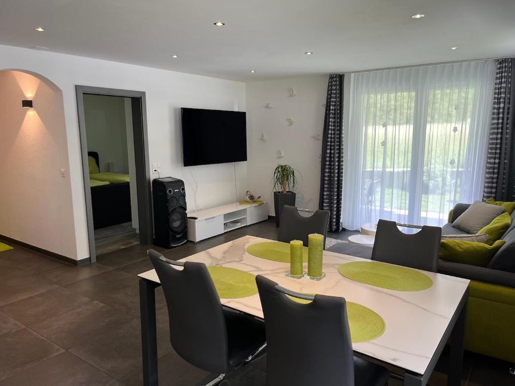 a living room with a table and a couch at Papillon in Saas-Grund