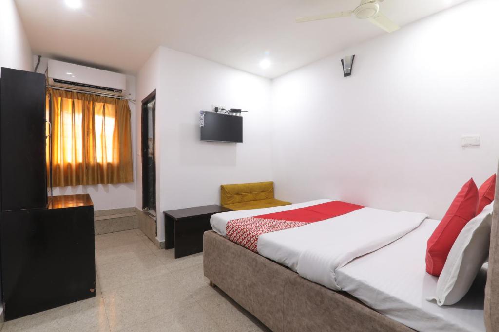 a small bedroom with a bed and a window at Hotel Metro Regency in Lucknow