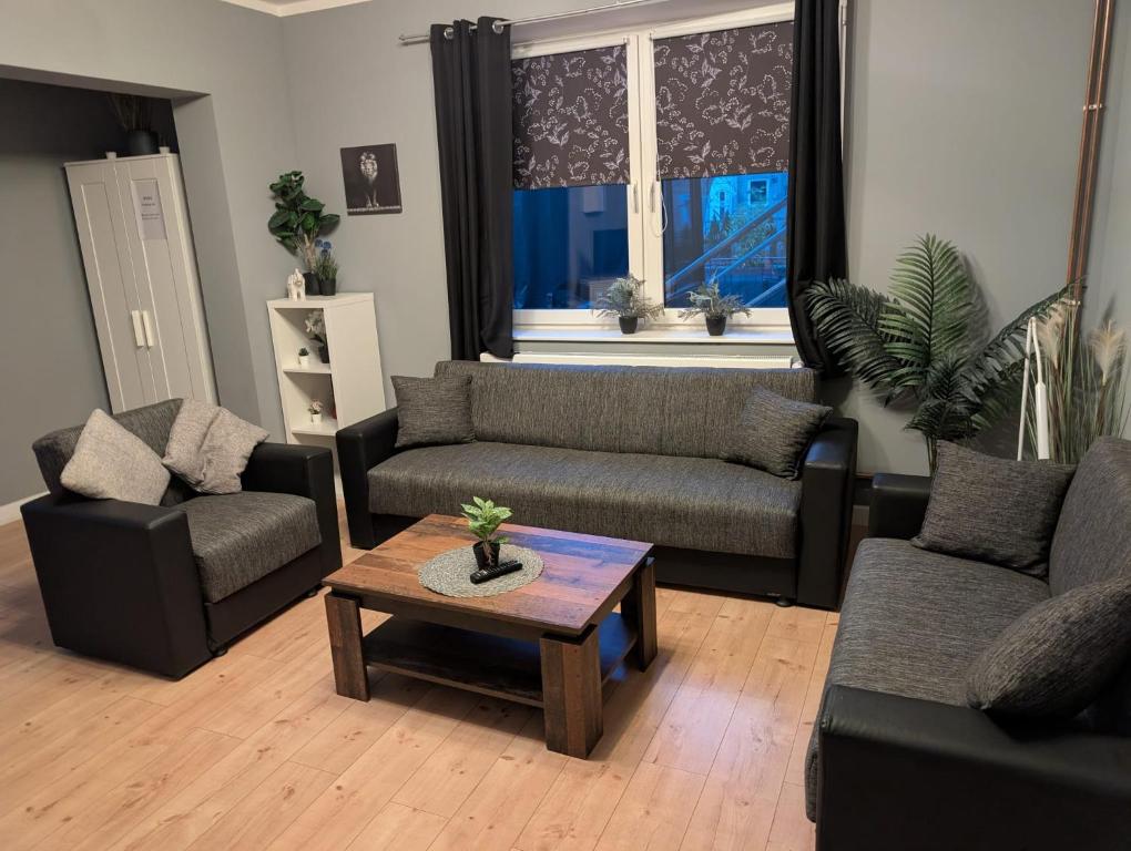 a living room with two couches and a coffee table at Flensburg Süd in Flensburg