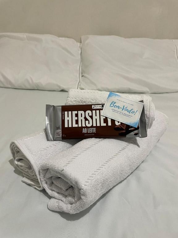 a pile of towels and a tube of toothpaste on a bed at Suite in Arraial do Cabo in Arraial do Cabo