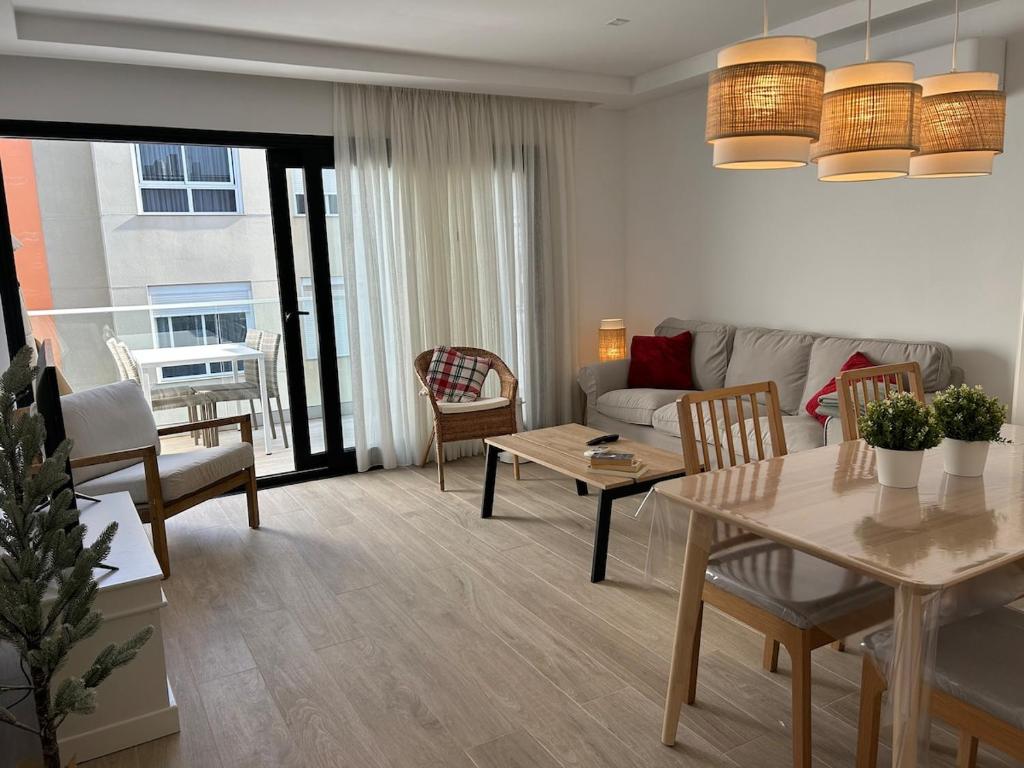 a living room with a couch and a table at Arguineguín sol y playa in Arguineguín