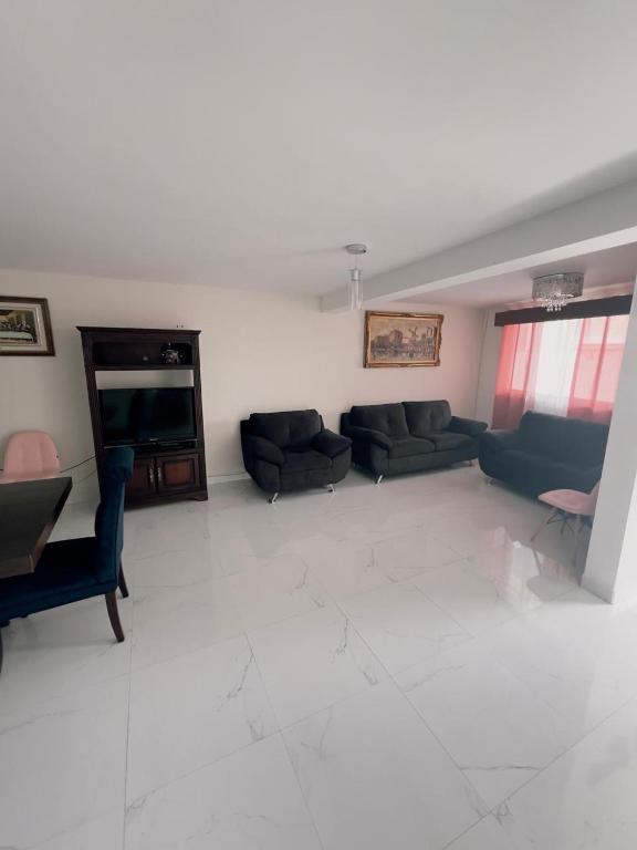 a large living room with couches and a television at Casa Analco Durango in Durango