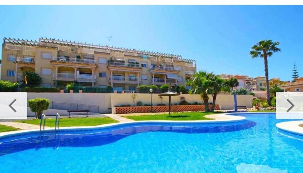 a large swimming pool in front of a building at Casanova in Calpe