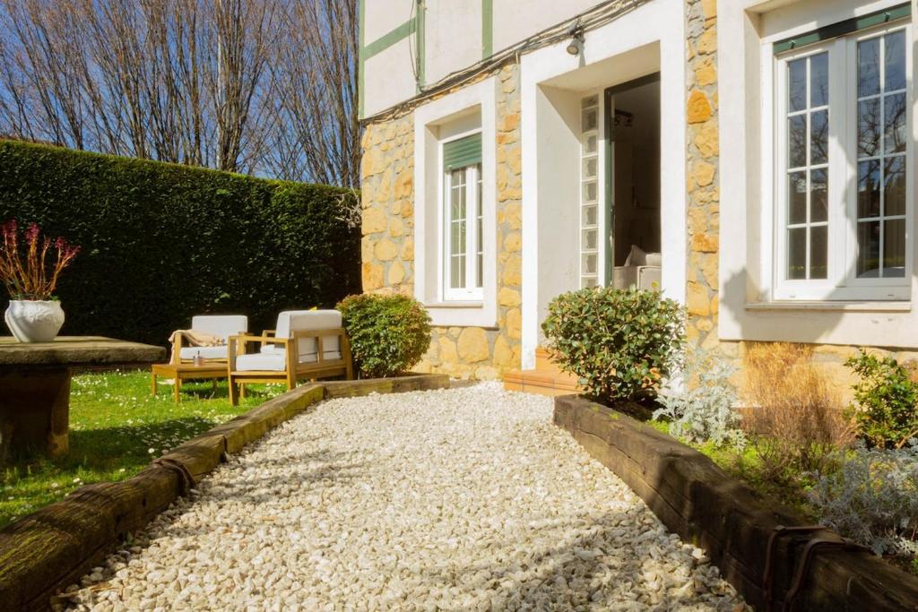 a house with a gravel path in front of it at Arbide House in Leioa