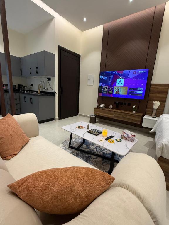 a living room with a couch and a tv at Nafel Modern Suite in Riyadh