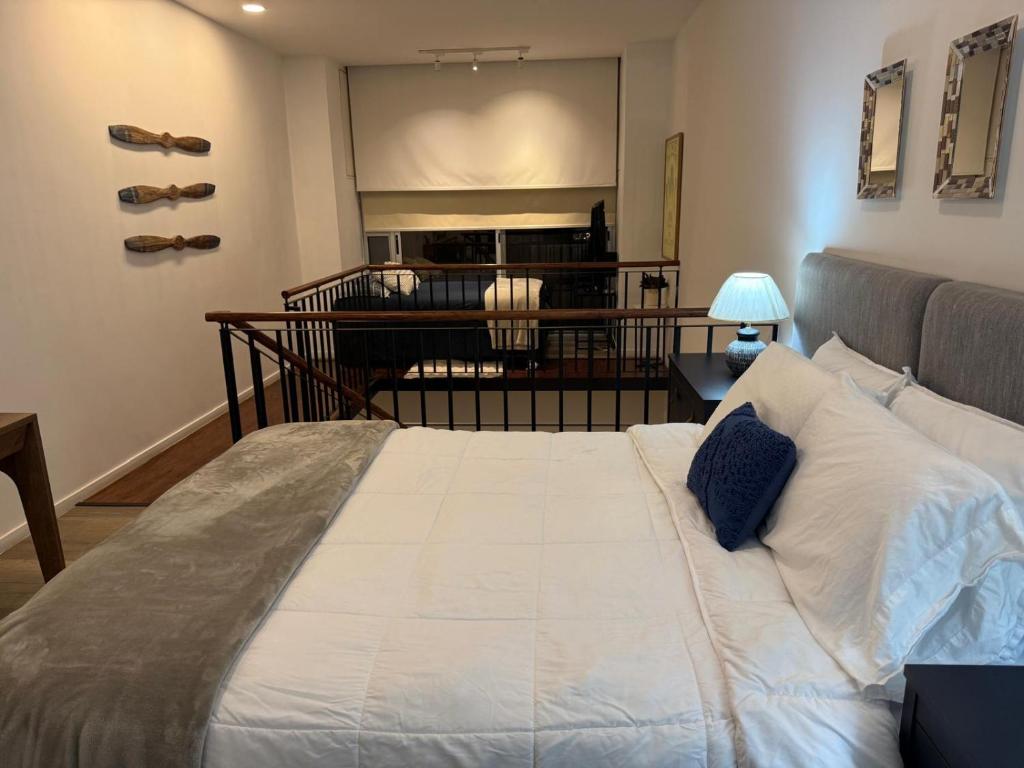 a bedroom with a large white bed in a room at Charming and Relaxing Home in Guatemala