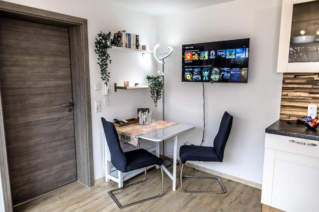 a small kitchen with a table and two chairs at Ferienwohnung Elsbeth in Biberach an der Riß