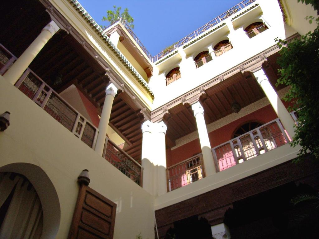 an old house with columns and a balcony at Dar Taliwint in Marrakech