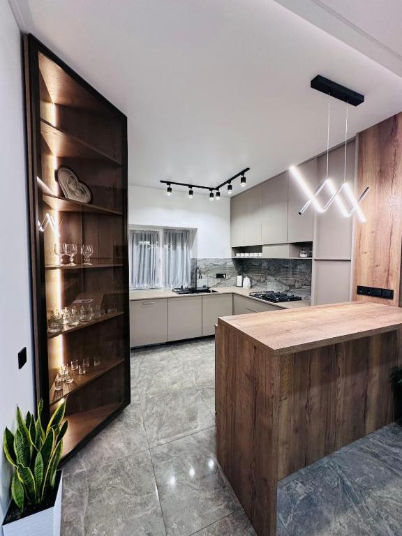 a kitchen with white cabinets and a wooden counter top at Brick House in Slavske