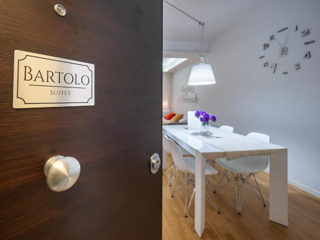 a dining room with a white table and white chairs at Bartolo Suite Centro Storico Perugia in Perugia