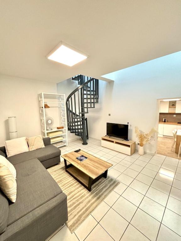 a living room with a couch and a table at Charmant Duplex - Hyper Centre - 44m2 - Proche Place Stanislas in Nancy