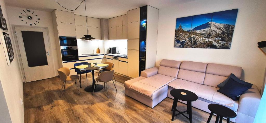 a living room with a couch and a table at Apartmán Riverside Labe Vrchlabí in Vrchlabí