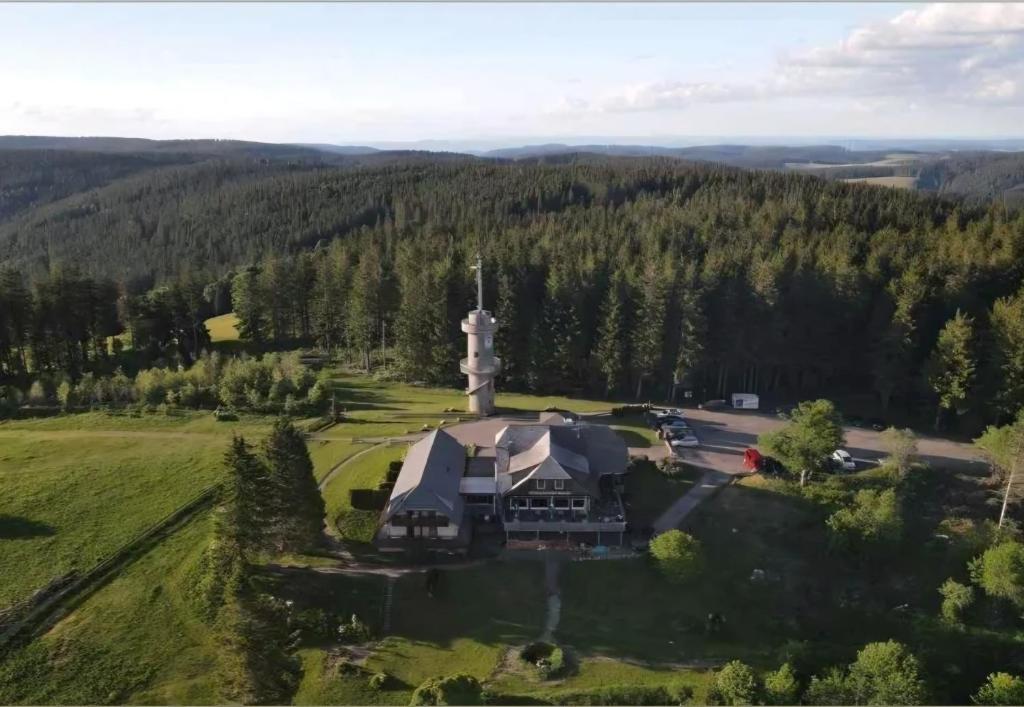 an aerial view of a house with a church at Brend Hotel und Gasthof in Furtwangen