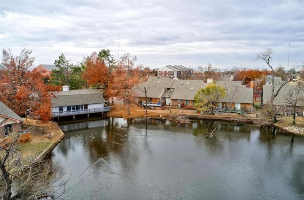 a view of a river with houses and buildings at Gated Lakefront Retreat in Edmond