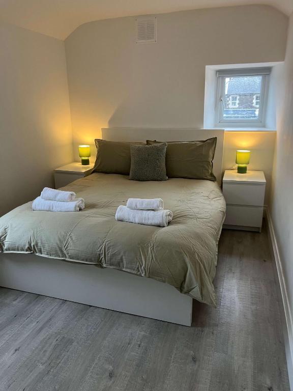 a bedroom with a bed with two towels on it at 1 Bed Room Flat Close to seafront in Weston-super-Mare