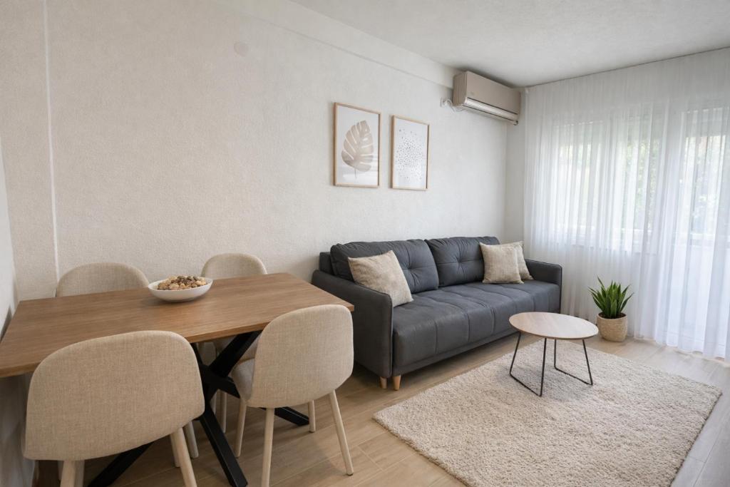 a living room with a couch and a table at Block and Svemir Suiets in Kumanovo