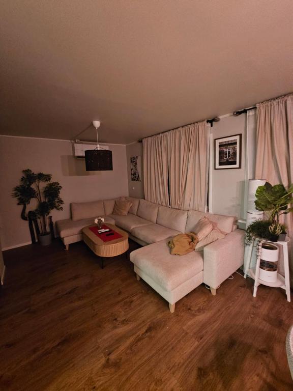 a living room with a couch and a table at Cozy 3-Bedroom Home in Forus in Stavanger