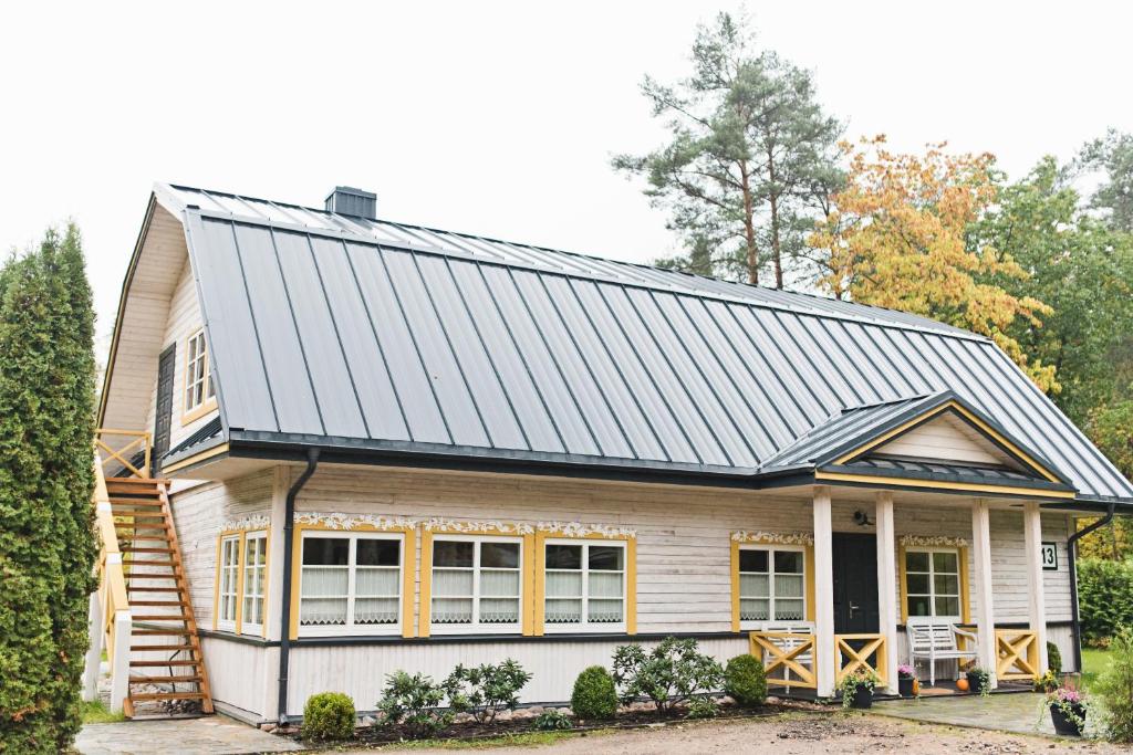 a house with a metal roof at Villa Kurorto Namas in Druskininkai