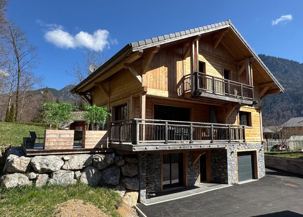 a large wooden house with a balcony on top at Chalet Frantz'y in Saint-Jean-d'Aulps