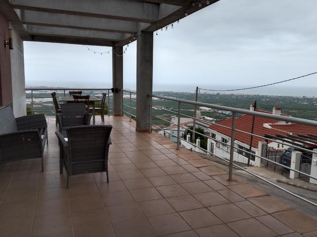 a balcony with chairs and a table and a view at Tossal Home Lounge in La Font d'en Carròs
