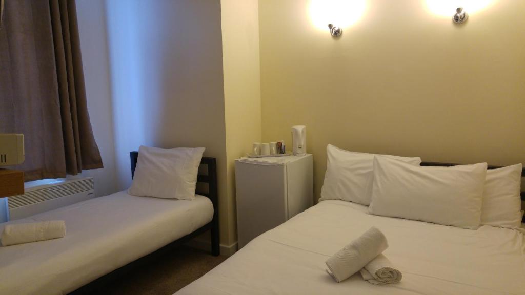 Postel nebo postele na pokoji v ubytování City View Hotel Stratford