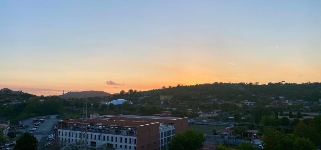 a view of a city with the sunset in the background at casa picasso in Naples