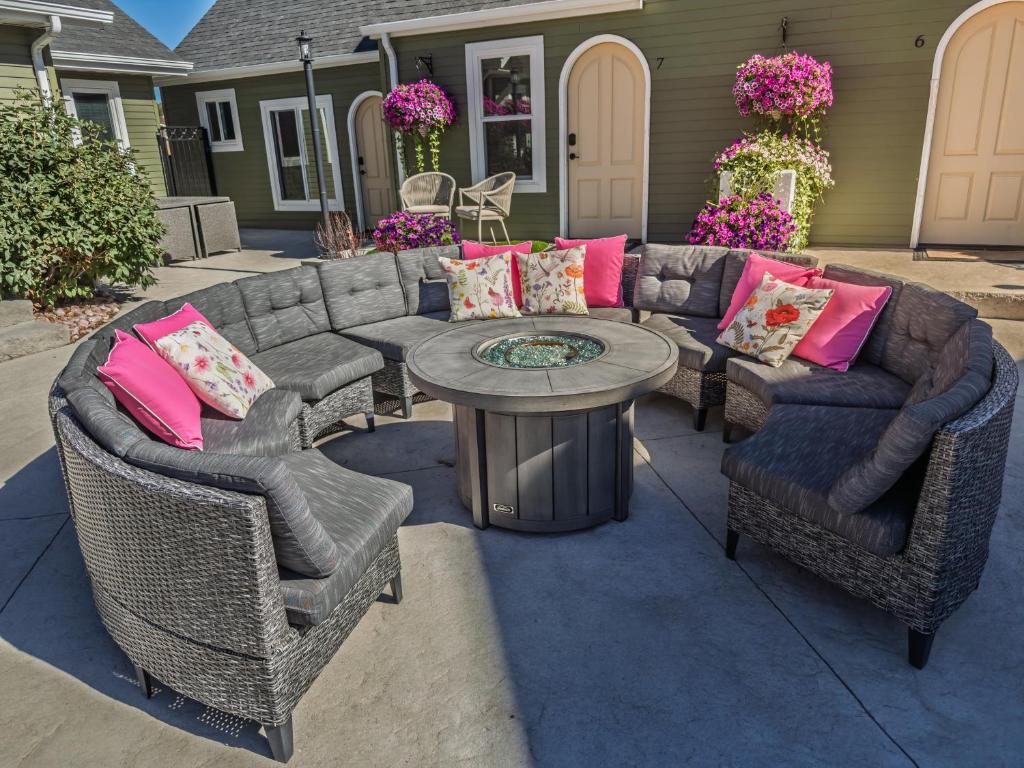 a patio with a couch and chairs and a table at EO Bungalows, Black Hills in Custer