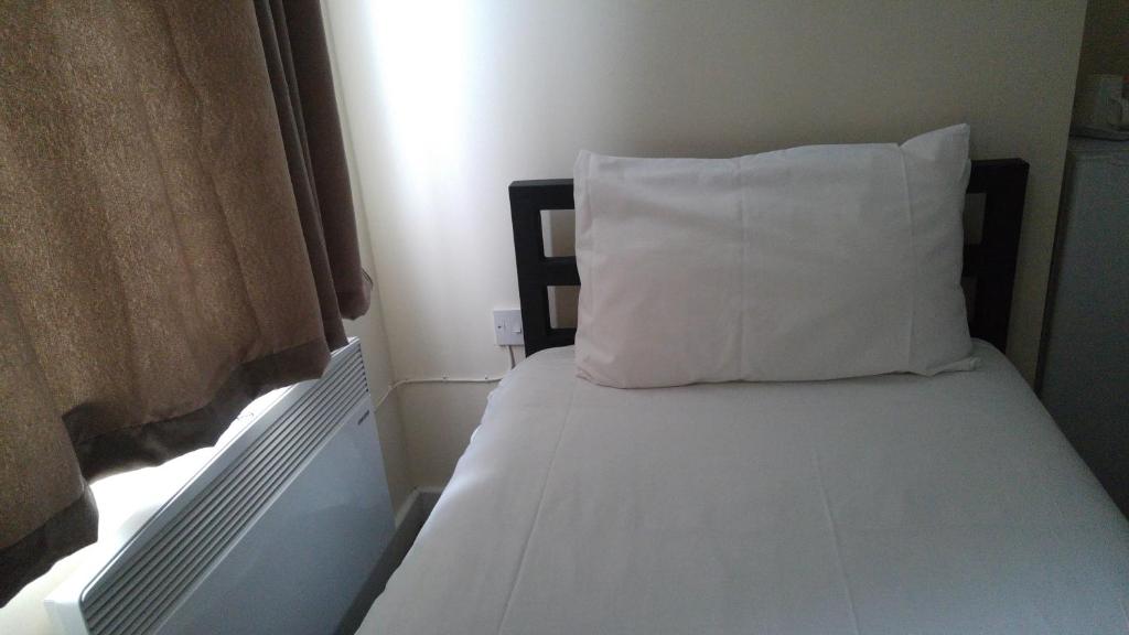 Postel nebo postele na pokoji v ubytování City View Hotel Stratford