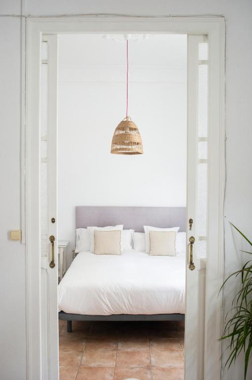 a bedroom with a bed through a door at ABCyou Bed&Breakfast in Valencia