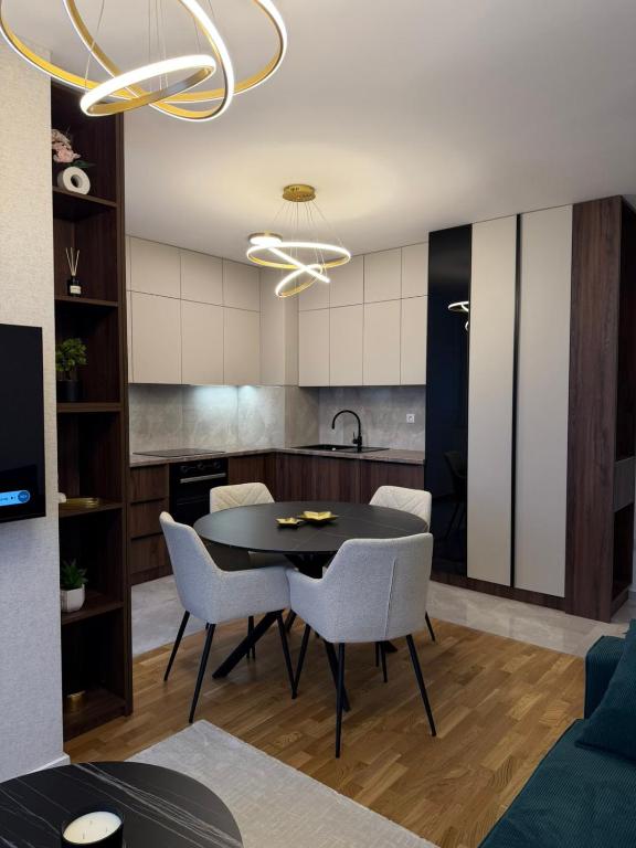 a kitchen and dining room with a table and chairs at Stelmar Apartment in Banja Luka