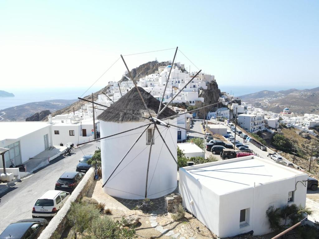 a windmill on the side of a building at Traditional Windmill House , Chora Serifos in Serifos Chora
