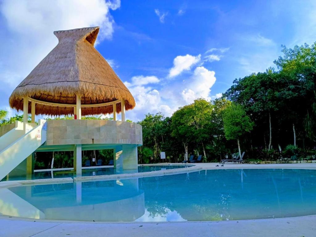 a swimming pool with a gazebo in a resort at Casa Balam en Puerto Morelos in Puerto Morelos